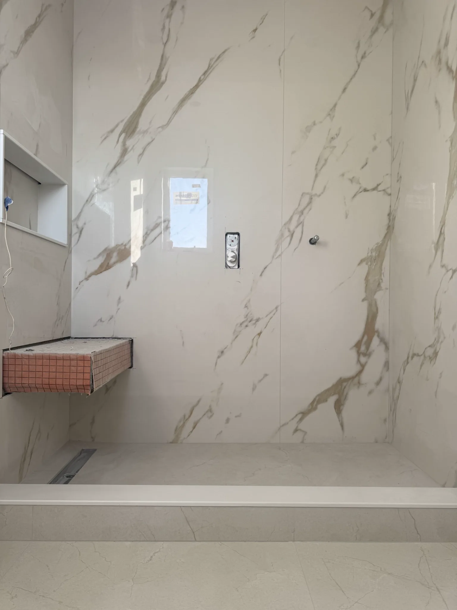 Large-format marble-look slab shower installation by Zafar Tile